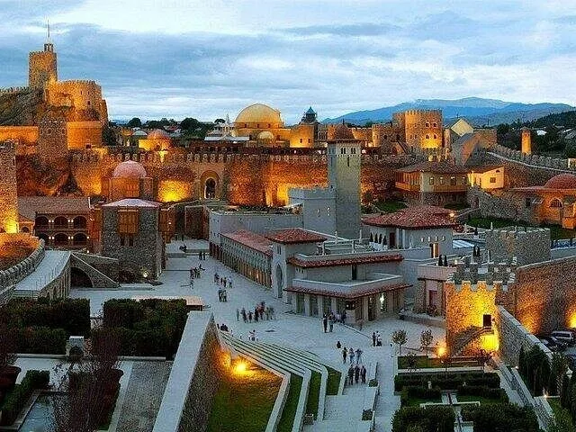 Evening view of the historic Rabati Castle complex illuminated against the sky