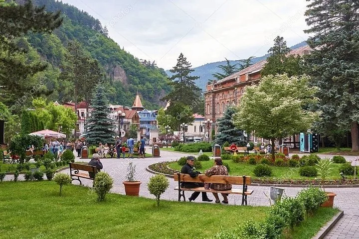 People relaxing on benches in the landscaped grounds of Borjomi Central Park