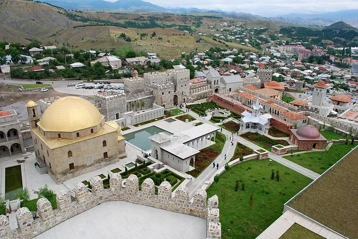 Aerial view of Rabati Castle complex featuring a mosque with a golden dome