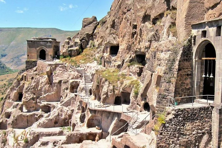 Vardzia cave city featuring rock-hewn architecture, stairs, and historical structures in Georgia